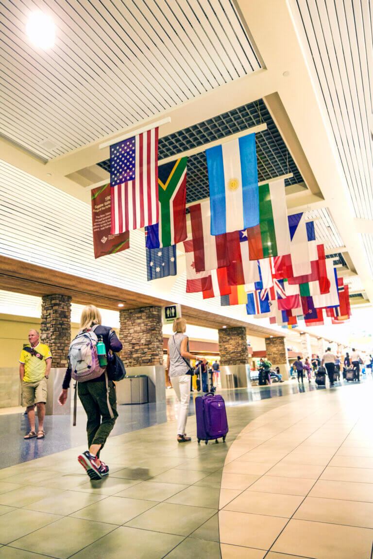 Historic flag display hanging in the baggage claim and rental car area.