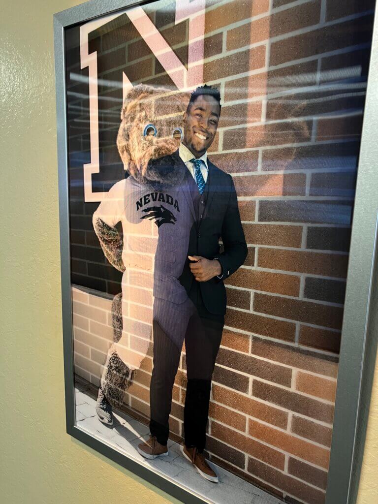 Lenticular two-flip panels art piece of man and Wolf Pack mascot.