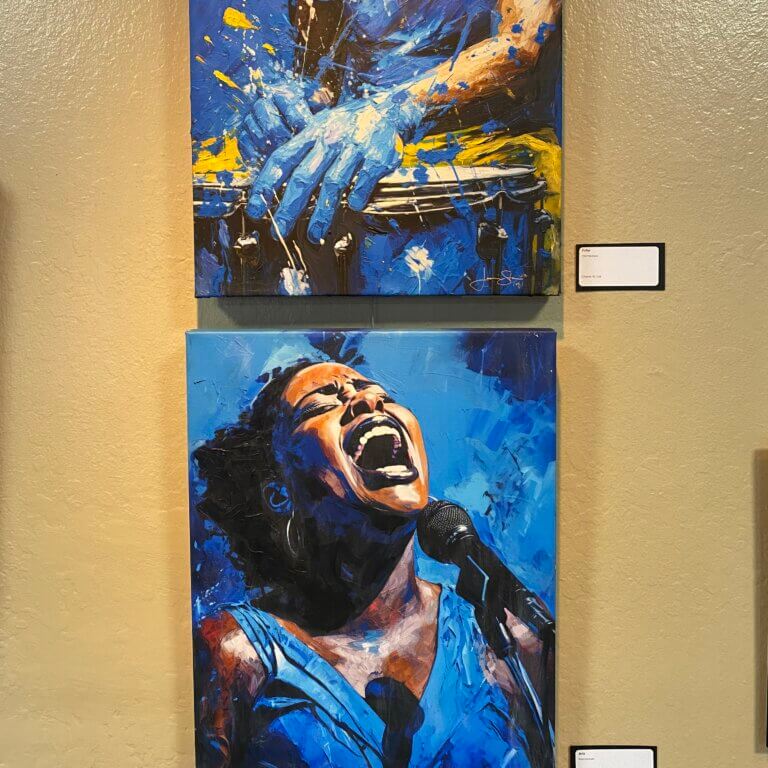 Photo of two canvasses with images of a singer and a drummer.