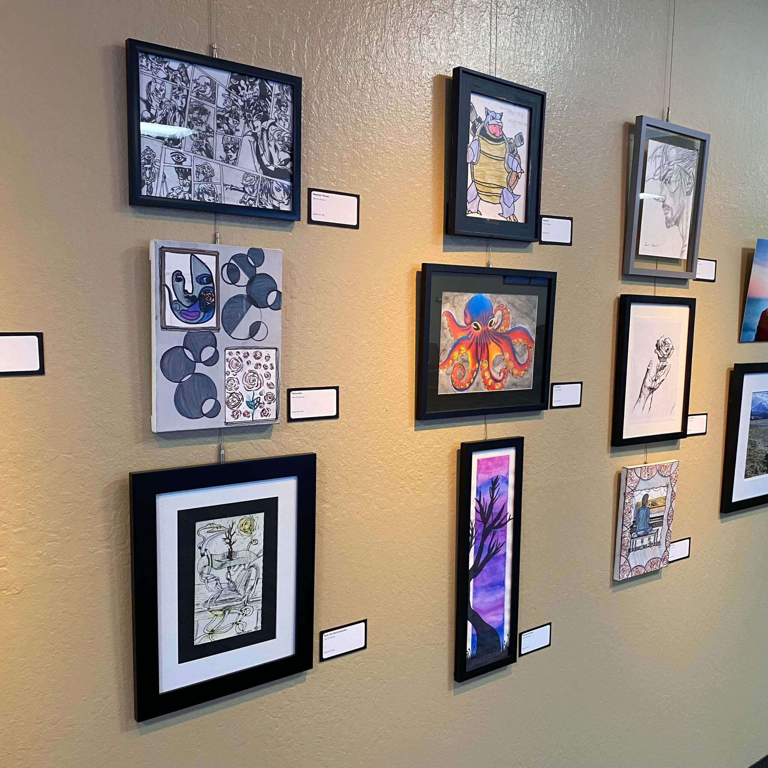 Photo of Employee Art Show gallery wall.