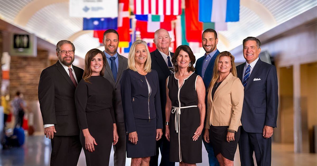 Reno-Tahoe Airport Authority Board of Trustees posing for a photo. From left to right: Art Sperber, Cortney Young, Joel Grace, Carol Chaplin, Shaun Carey, Jennifer Cunningham, Adam Kramer, Kitty Jung, and Richard Jay.