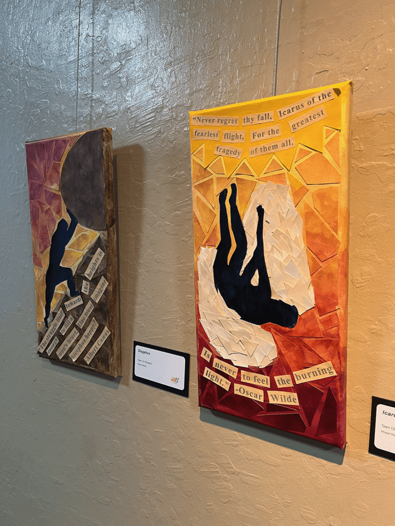Two art pieces hanging on gallery wall