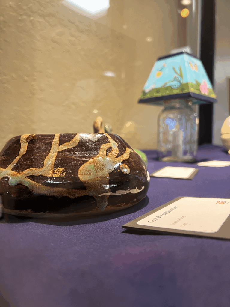Ceramic serpent bowl in art gallery display case