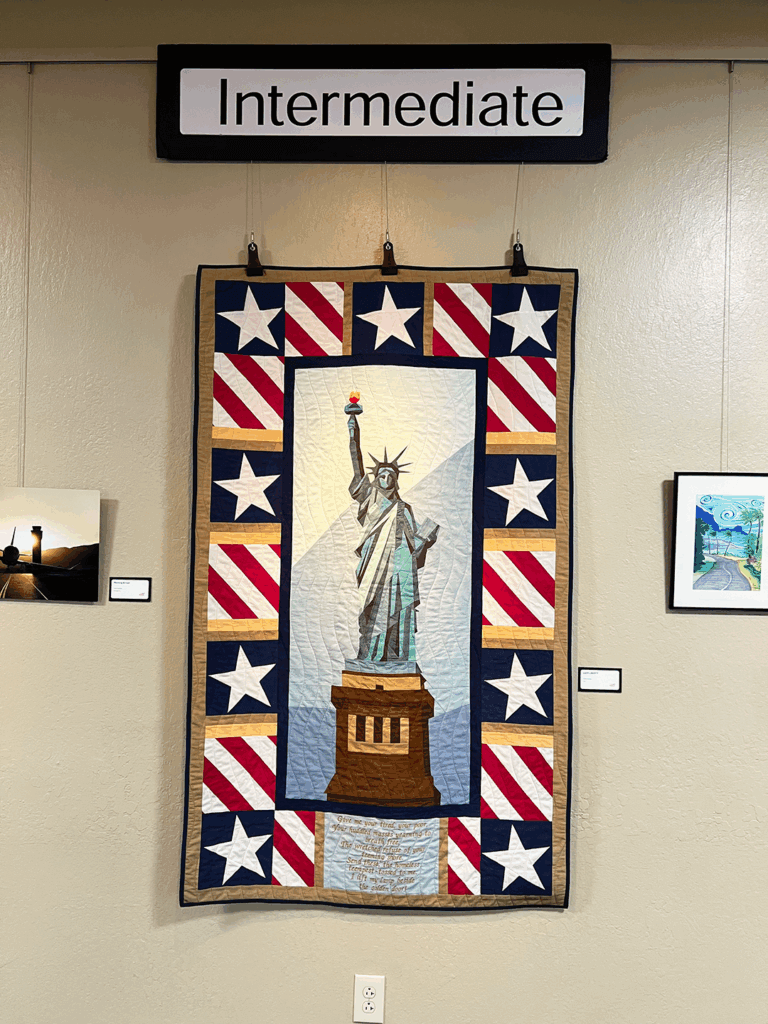 Quilt of Statue of Liberty hanging in art gallery