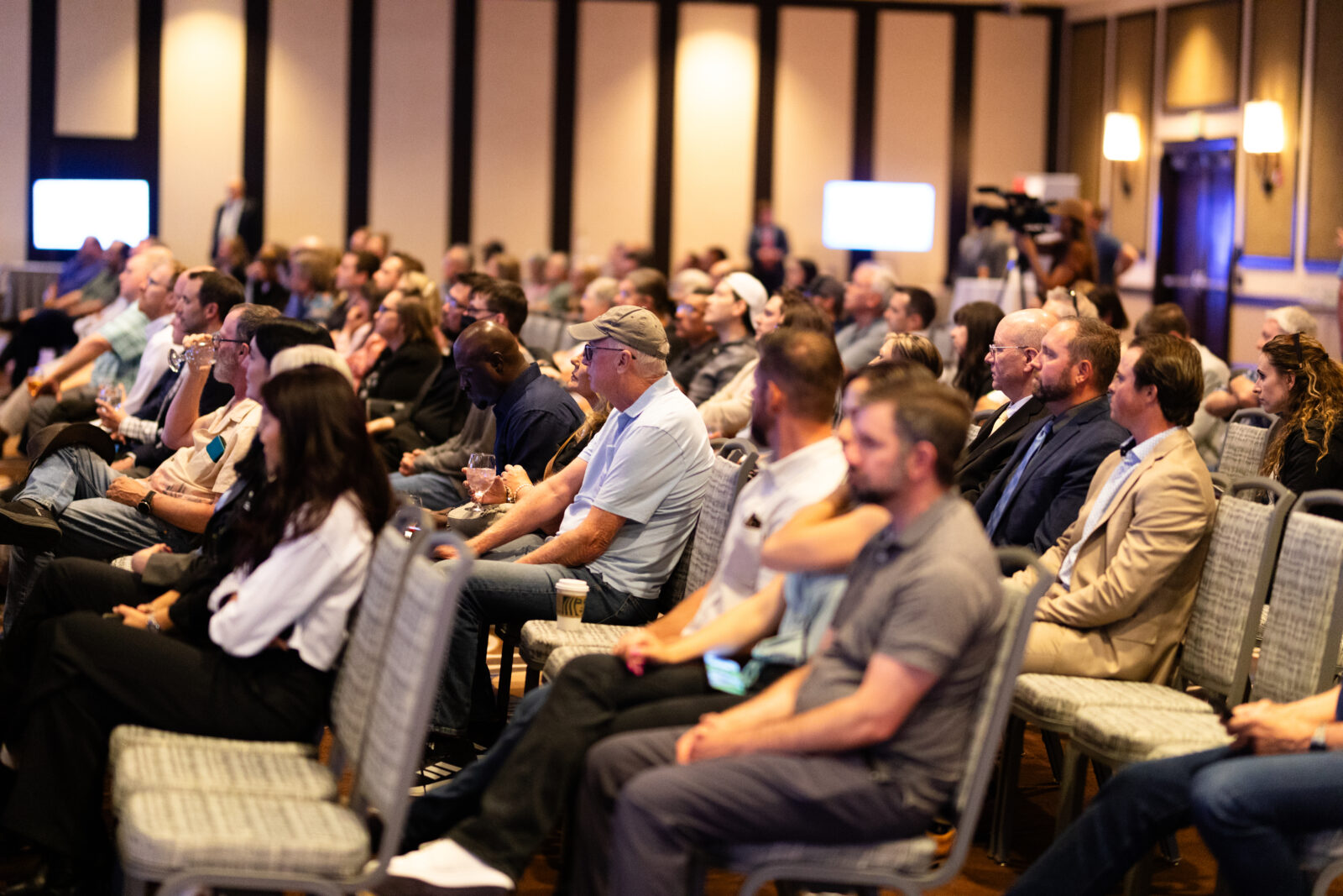 Photo of a full room of people in seats