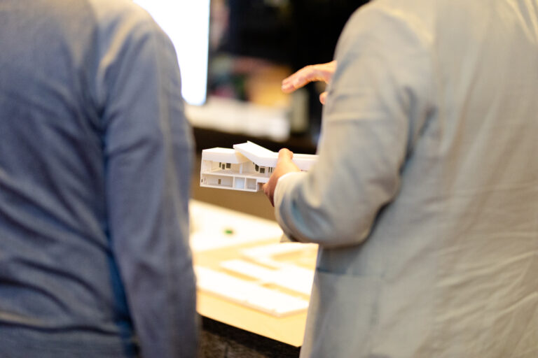 Image of man holding a 3D model of the airport concourses