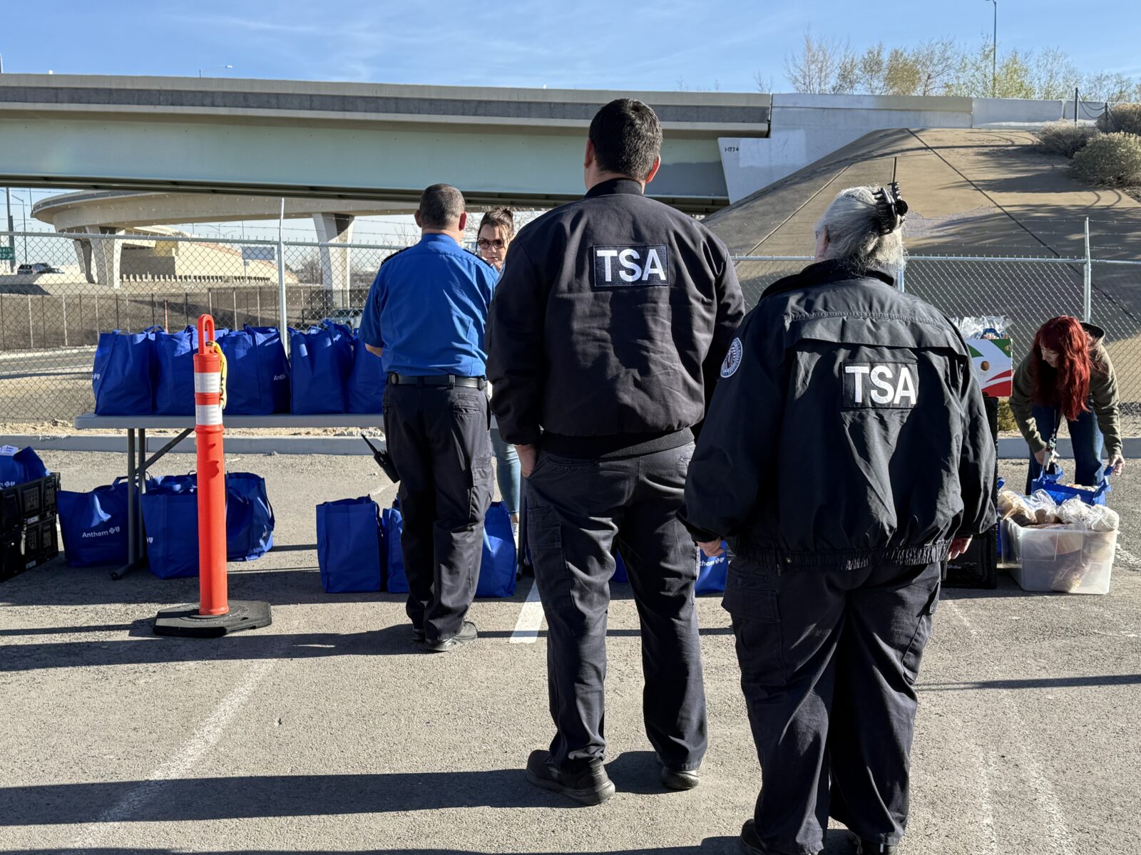 TSA officers standing in line at Children's Cabinet grocery drop off