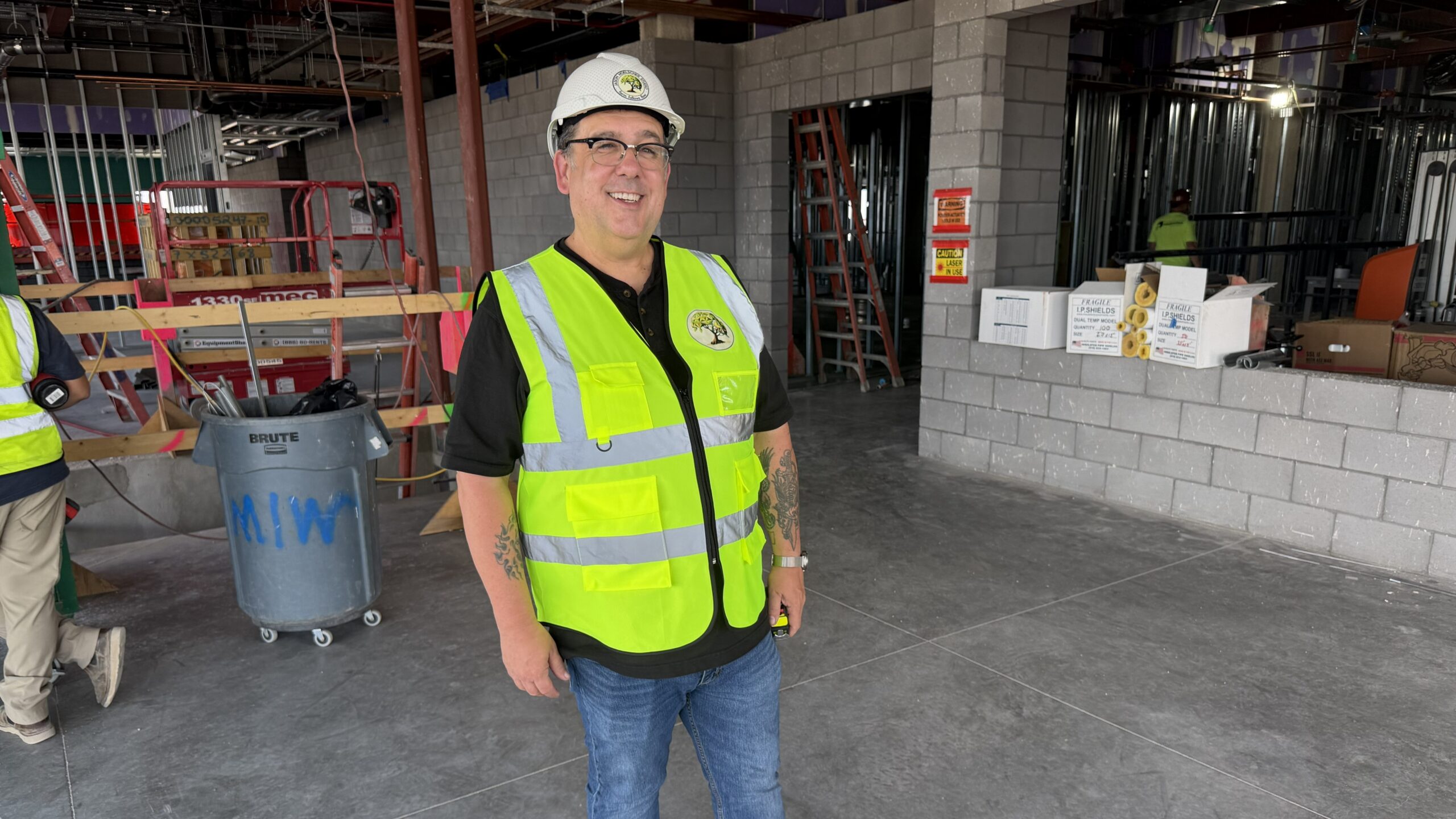 Jason Holescher, artist, stands in the HQ construction site where he will install his artwork in the interior entryway lobby.